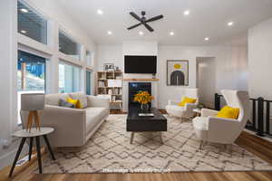 Living room featuring ceiling fan and light hardwood / wood-style floorsVirtually staged