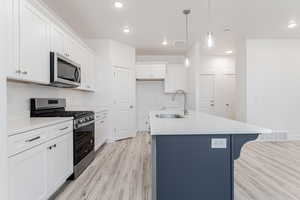 Kitchen with visible vents, recessed lighting, a sink, light wood-style floors, and appliances with stainless steel finishes