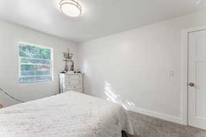 Carpeted bedroom featuring a textured ceiling