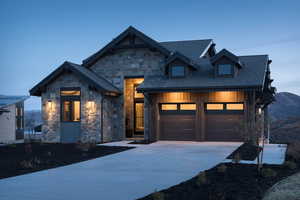 View of front of home with a garage and a mountain view