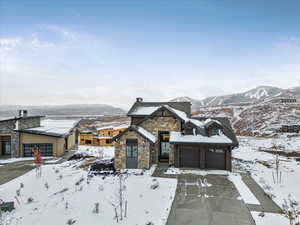 View of front of house with a mountain view and a garage