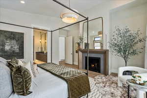 Bedroom featuring ensuite bathroom and hardwood / wood-style flooring