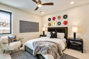 Carpeted bedroom featuring ceiling fan