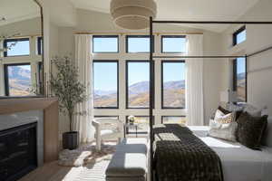 Bedroom featuring lofted ceiling, a mountain view, and hardwood / wood-style floors