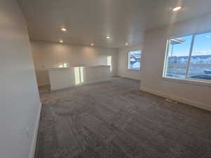 Unfurnished room with dark colored carpet