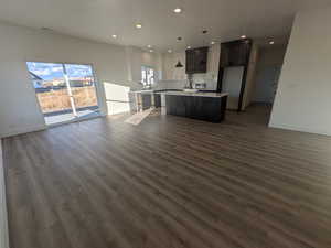 Unfurnished living room with dark wood-type flooring