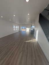 Unfurnished living room featuring dark hardwood / wood-style flooring