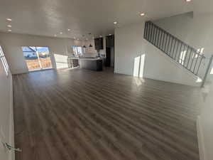 Unfurnished living room featuring dark hardwood / wood-style floors