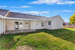 Back of house featuring a yard and a patio area