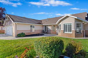 Single story home with a front yard, a garage, and a patio