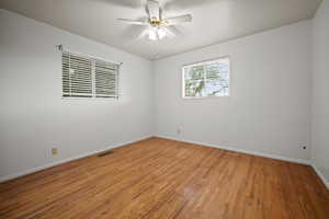 Unfurnished room featuring hardwood / wood-style floors and ceiling fan