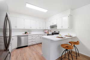 Bright, open kitchen with new stainless steel appliances - all included!