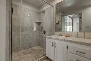 Master bathroom with vanity and a shower with shower door