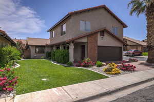 View of front of house with a front lawn and a garage