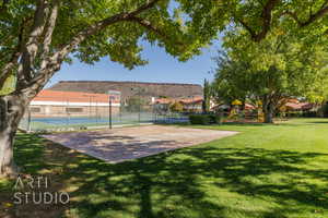 Exterior space featuring a playground, a yard, and basketball hoop