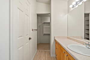 Primary suite with walk in closet and bathroom