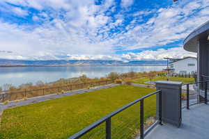 Balcony with a water and mountain view