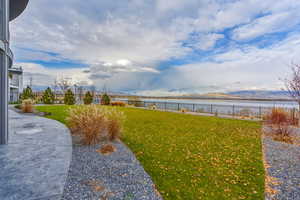 Fenced backyard featuring a water view