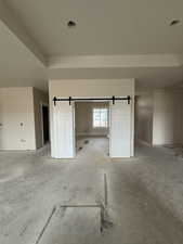 Unfurnished room with a barn door