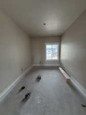 Empty room featuring a textured ceiling