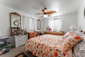 Bedroom featuring ceiling fan and light carpet