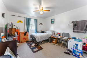 Carpeted bedroom with ceiling fan