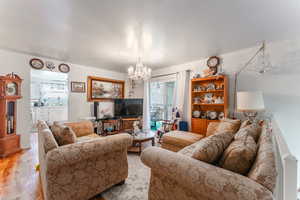 Living room featuring light hardwood / wood-style flooring and an inviting chandelier