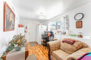 Living room with light hardwood / wood-style floors