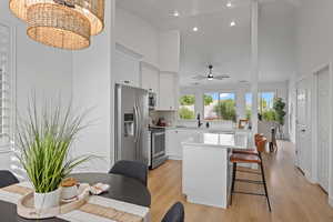 Kitchen with sink, white cabinets, light wood-type flooring, appliances with stainless steel finishes, and ceiling fan