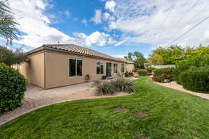 Back of property featuring a yard and a patio area