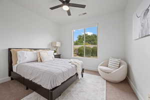 Bedroom with light colored carpet and ceiling fan