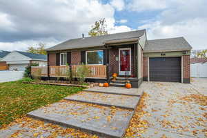 Single story home featuring a garage and a front lawn