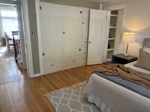 Bedroom featuring hardwood floors with access from dining room