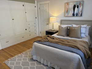 Bedroom featuring builtins & closet