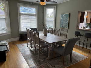 Dining room featuring hardwood flooring, radiator, plenty of natural light, and ceiling fan