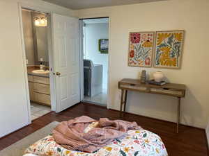 Bedroom featuring ensuite bath 3/4 bathroom and dark wood-type flooring