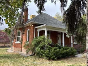 View of side of home featuring covered porch