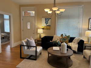 Living room with a chandelier and light hardwood floors