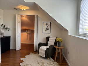 Upstairs bedroom with sitting area and walk-in closet