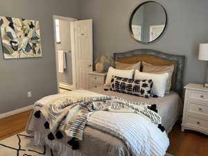 Bedroom featuring ceiling fan & attached full bathroom