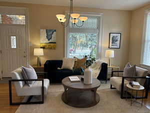 Living room with light hardwood floors and and leaded glass windows