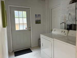 Laundry area with electric panel and washing machine and clothes dryer