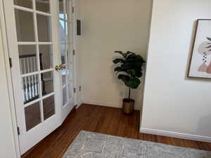 Office/ nursery with french doors, dark hardwood / wood-style flooring and attached full bathroom