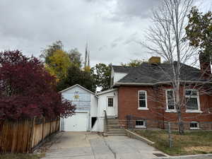 View of side of property with a garage & driveway