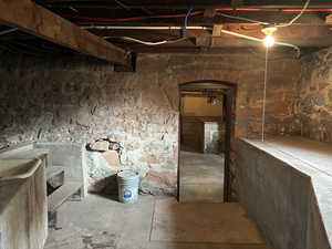 View of basement with exterior entrance and utility sink