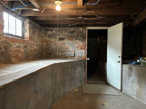 View of basement with exterior entrance & utility sink