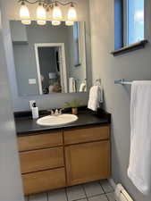 Bathroom with vanity, tub, shower and tile floors