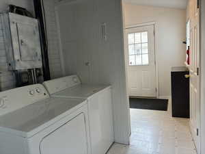 Laundry room fand mud room featuring electric panel and separate washer and dryer