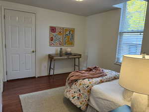 Bedroom/ office featuring dark wood-type flooring