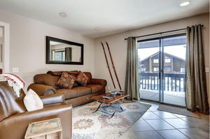 Living room with light tile patterned flooring